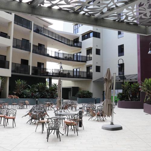 Outdoor communal area showing 2 of 3 buildings in the background.