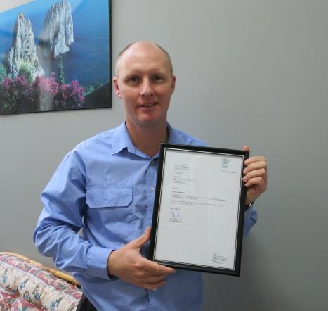 Paul with accreditation certificate