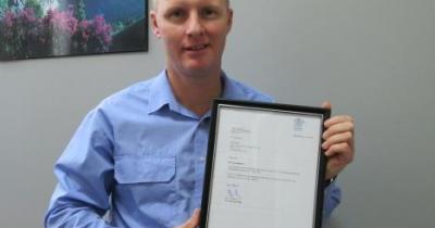 Paul with accreditation certificate