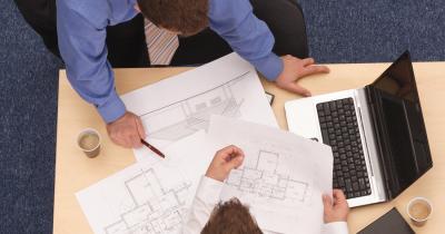 Going over plans on desk